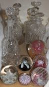 A silver topped glass decanter together with assorted glass decanters,