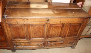 An 18th century oak coffer with a planked top and base drawers