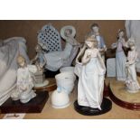 Seven assorted Lladro figures, including a girl on a chaise longue, girls with flowers,