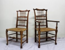 A set of ten Liverpool ash spindle back dining chairs with rush sets on turned legs on pad feet,