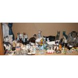 A Poole pottery seated cat together with a large quantity of model cats including Royal Crown Derby,