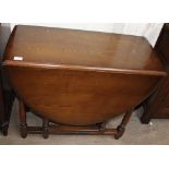 A 20th century oak gateleg dining table together with a set of four ladder back dining chairs and a