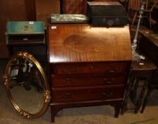 A reproduction mahogany bureau together with a carved oak drop leaf table an oak bookcase,