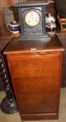 An oak drop front filing cabinet together with an ebonised mantle clock