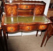 A reproduction mahogany ladies writing table with a raised superstructure above a leather writing