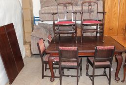 An Edwardian mahogany extending dining table on cabriole legs and pad feet on casters,