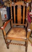 A 20th century oak elbow chair