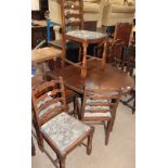 A 20th century oak gate leg dining table together with four ladder back dining chairs