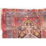 A 19th century Bakhitari rug with a red ground and central medallion