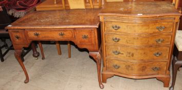 A 20th century walnut writing table with a cross banded top above three drawers on shell capped