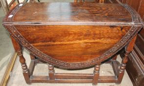 An oak gate leg dining table,
