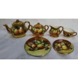A Coalport fruit painted miniature part tea set, comprising a teapot, cream jug,