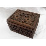 A carved oak Cigar box, carved with dragons and serpents, 21.