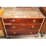 A Victorian pine chest with two short and three long drawers on bun feet,