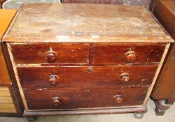 A Victorian pine chest with two short and three long drawers on bun feet,