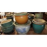 A large collection of stoneware plant pots