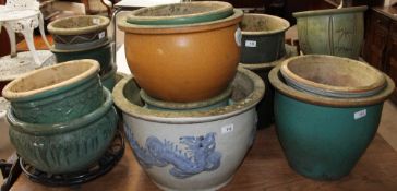 A large collection of stoneware plant pots