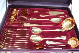A Solingen gold plated flatware service, with a beaded edge and a place setting for twelve,