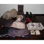 A Japanese souvenir doll together with another doll, a rabbit teddy bear, playing cards,