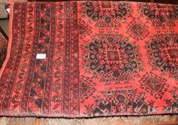 A red ground rug with geometric patterns