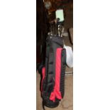 A golf bag, golf trolley, golf clubs,