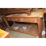 A large pine kitchen serving table with three drawers on square legs united by a pot board