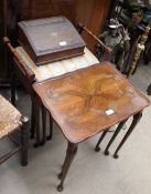 A 20th century walnut nest of tables together with a piano stool, a laptop desk,