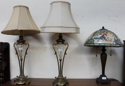 A pair of brass and glass table lamps in the form of vases,