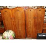 A 20th century walnut three piece bedroom suite comprising two wardrobes and a dressing table