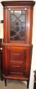 An Edwardian mahogany standing corner cupboard,