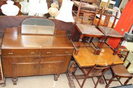 An oak mirror back sideboard together with an extending dining table and four chairs