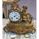 A Vincent & Cie Ormulu mantle clock with a circular dial and Roman numerals with a lady dancing