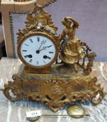 A Vincent & Cie Ormulu mantle clock with a circular dial and Roman numerals with a lady dancing