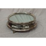 An electroplated wedding cake stand, of circular form with a mirrored plateau,
