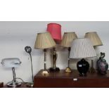 A set of three glass and brass table lamps together with other table and desk lamps