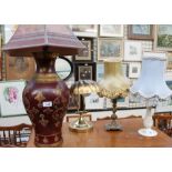 A pottery table lamp together with two other table lamps and a brass desk lamp