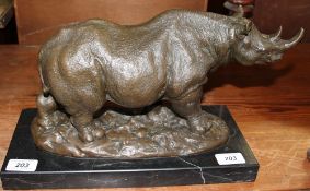 Milo A bronze model of a rhinoceros on a bronze or marble base