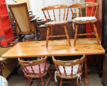 A pine kitchen table and four chairs