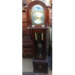 A reproduction mahogany three train grandmother clock with moon phase top