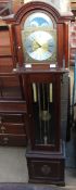 A reproduction mahogany three train grandmother clock with moon phase top