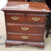 A reproduction mahogany chest with three drawers on bracket feet