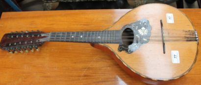 A twelve string banjo with mother of pearl inlay