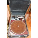 A leatherette covered table top gramophone and records