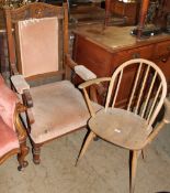 An Edwardian oak gentleman's chair together with a spindle back elbow chair