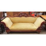 A Victorian walnut scroll arm settee with a shield and leaf carved back
