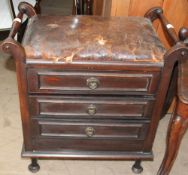 A 20th century piano stool with drop front drawers to the base