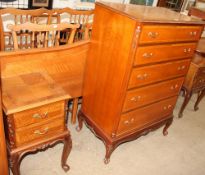 A walnut continental headboard together with a five drawer chest on cabriole legs and turned feet