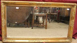 A large gilt wall mirror of rectangular form