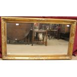 A large gilt wall mirror of rectangular form