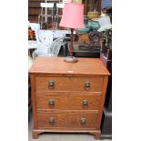 A 20th century oak chest with three long graduated drawers on bracket feet together with a table